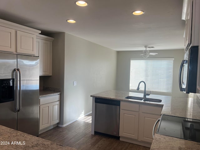 kitchen with stainless steel appliances, white cabinetry, sink, dark hardwood / wood-style floors, and ceiling fan