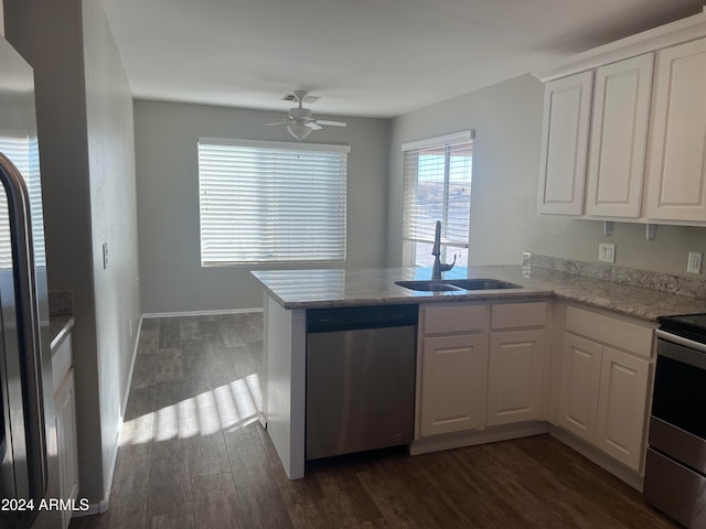 kitchen with kitchen peninsula, white cabinets, sink, and stainless steel appliances