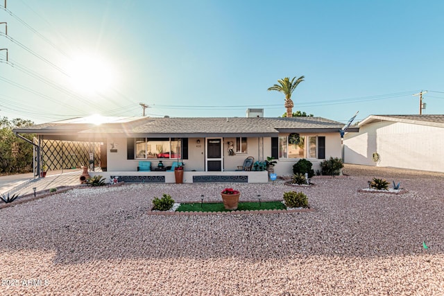 single story home featuring a carport and a porch