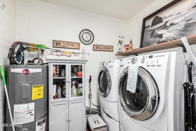 laundry room with cabinets, washer and clothes dryer, and electric water heater