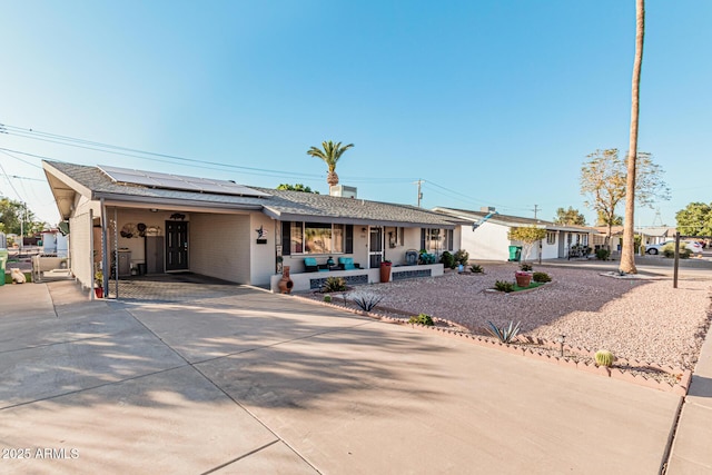 single story home with covered porch and solar panels