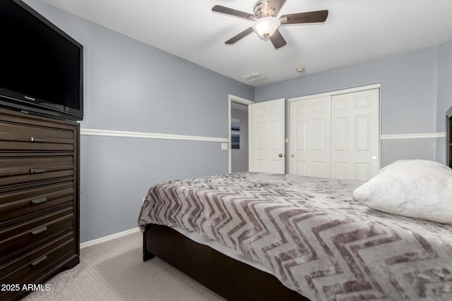 bedroom featuring light carpet, a closet, and ceiling fan