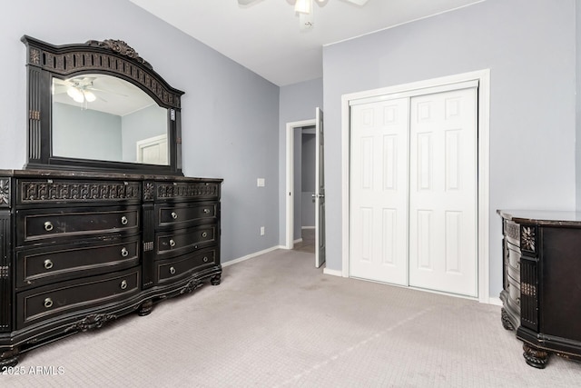 carpeted bedroom featuring ceiling fan and a closet