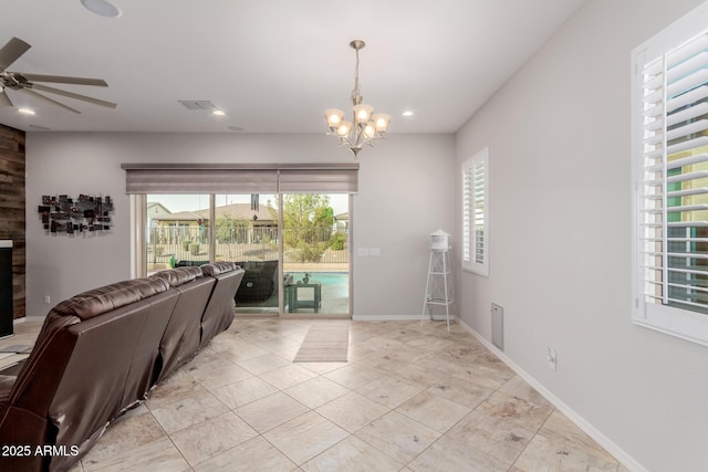 living area featuring recessed lighting, visible vents, baseboards, and ceiling fan with notable chandelier