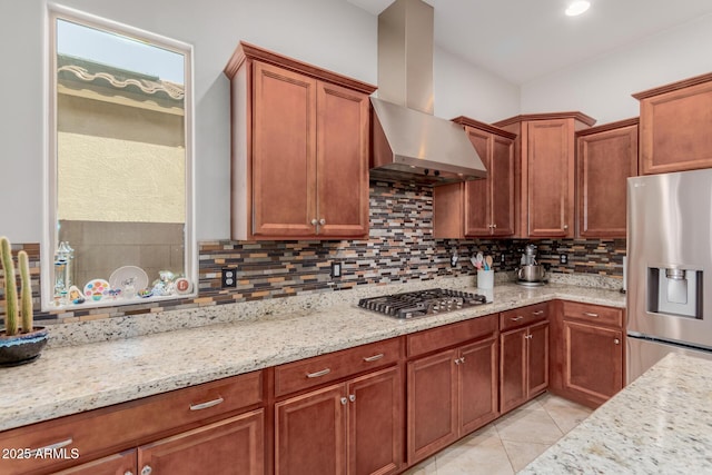 kitchen featuring light tile patterned floors, light stone counters, stainless steel appliances, backsplash, and range hood