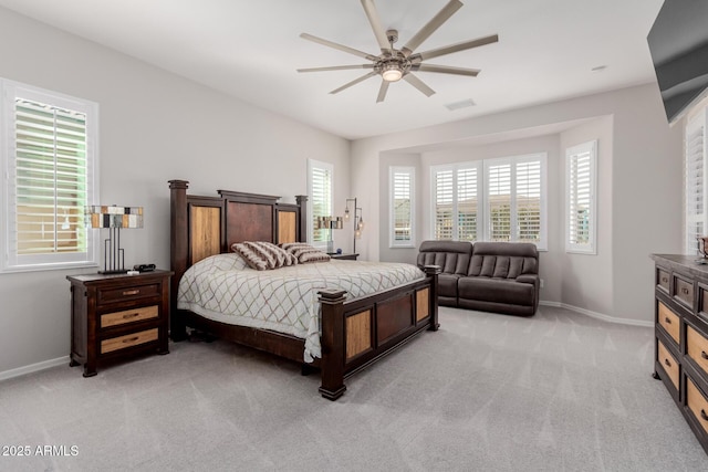 bedroom featuring baseboards, visible vents, and light colored carpet