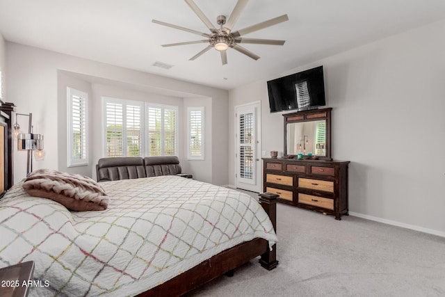 carpeted bedroom featuring access to exterior, baseboards, visible vents, and ceiling fan