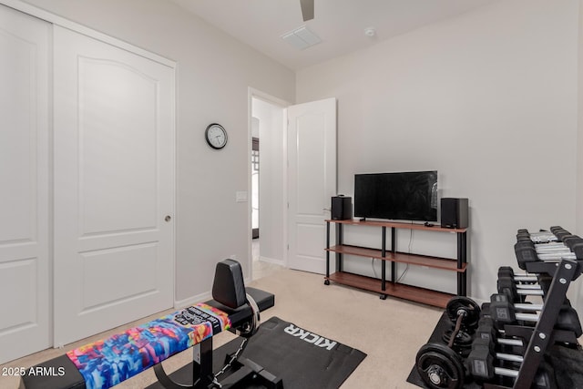 workout area featuring carpet floors, visible vents, baseboards, and a ceiling fan