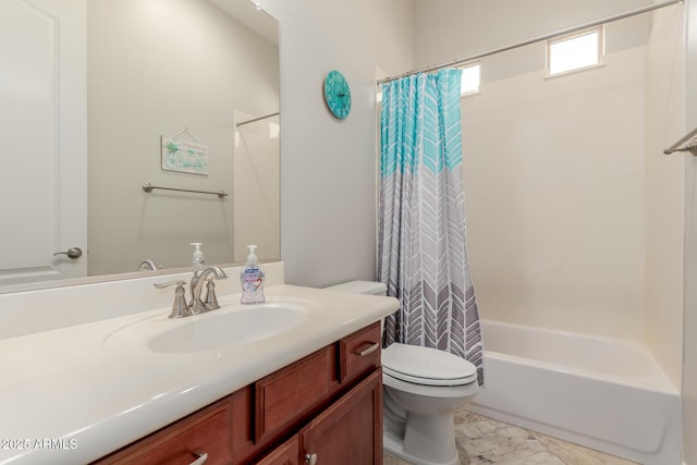 full bath featuring marble finish floor, vanity, shower / bath combo with shower curtain, and toilet