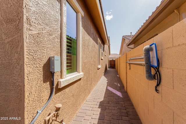 view of property exterior with a patio area, a fenced backyard, and stucco siding