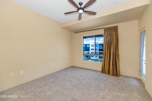 carpeted empty room featuring ceiling fan