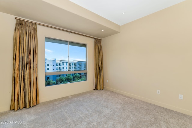 unfurnished room with light colored carpet