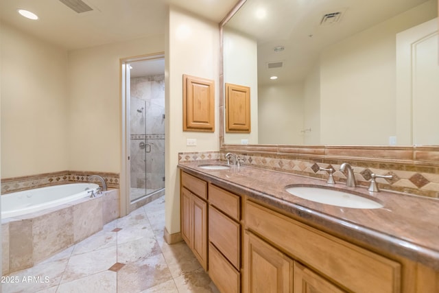 bathroom with tasteful backsplash, vanity, plus walk in shower, and tile patterned flooring