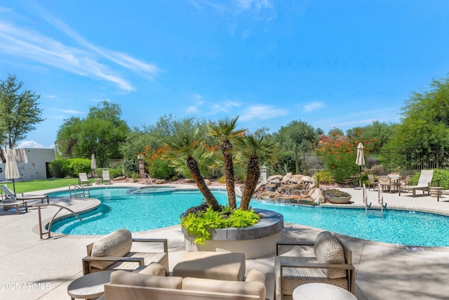 view of pool with a patio area and pool water feature