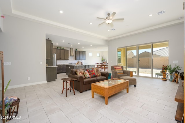 living room with ceiling fan and light tile patterned floors