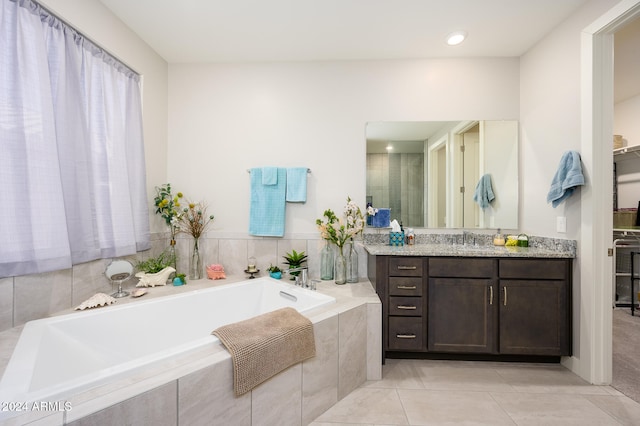 bathroom with vanity, shower with separate bathtub, and tile patterned flooring