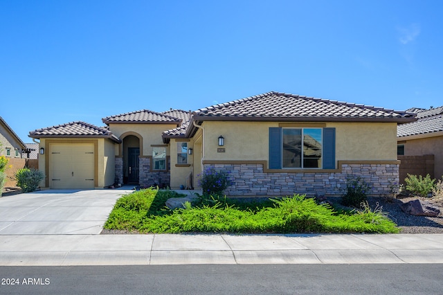 mediterranean / spanish-style home with a garage