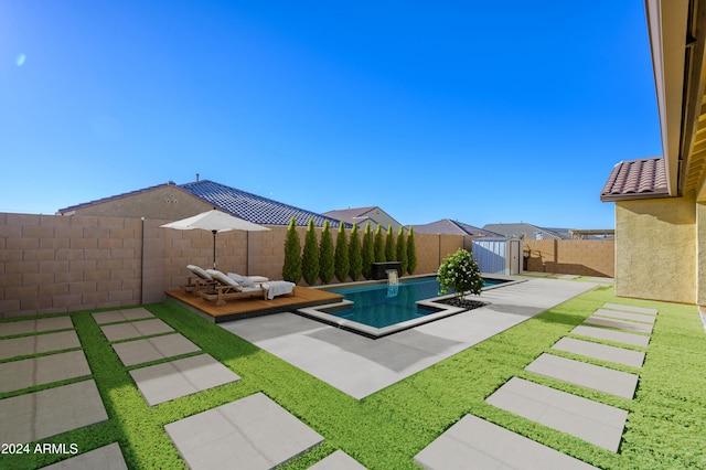 view of pool with a yard and a patio area