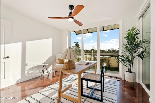 sunroom / solarium with a water view and ceiling fan