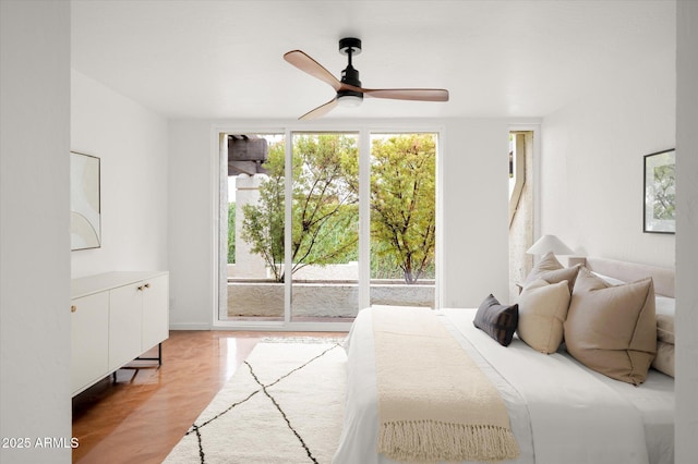 bedroom with ceiling fan, light wood-type flooring, and access to outside