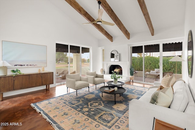 living room with beamed ceiling, ceiling fan, and high vaulted ceiling