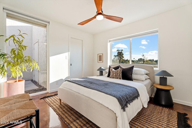 bedroom with dark hardwood / wood-style floors and ceiling fan