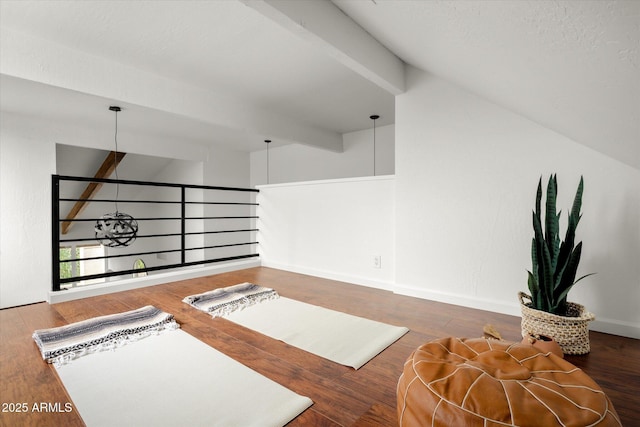 interior space with dark wood-type flooring and lofted ceiling with beams