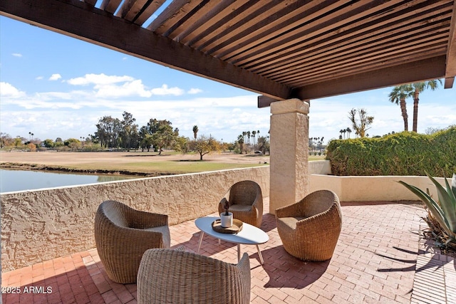 view of patio with a water view