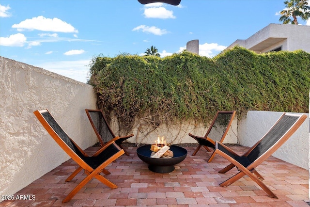 view of patio / terrace featuring an outdoor fire pit