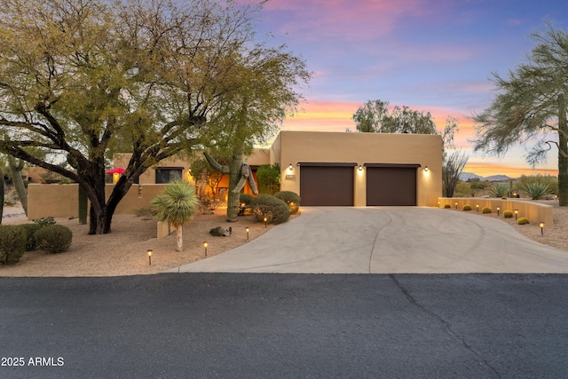 southwest-style home featuring a garage