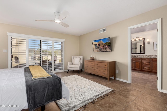 tiled bedroom featuring ceiling fan and ensuite bathroom