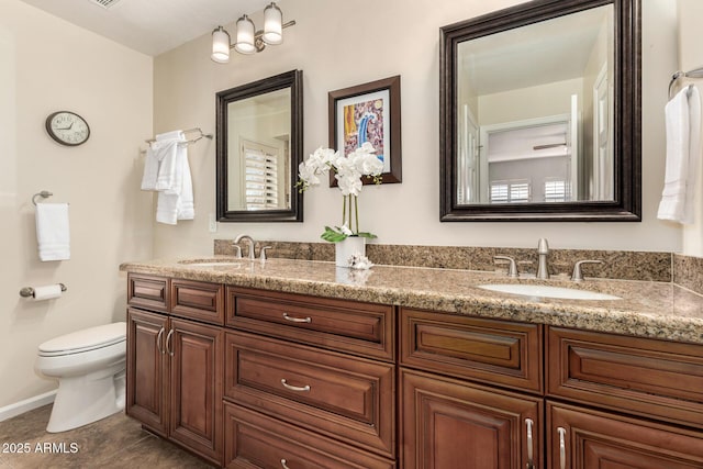 bathroom with vanity, toilet, and tile patterned flooring