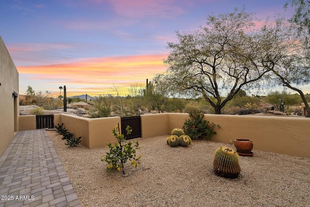 view of patio terrace at dusk