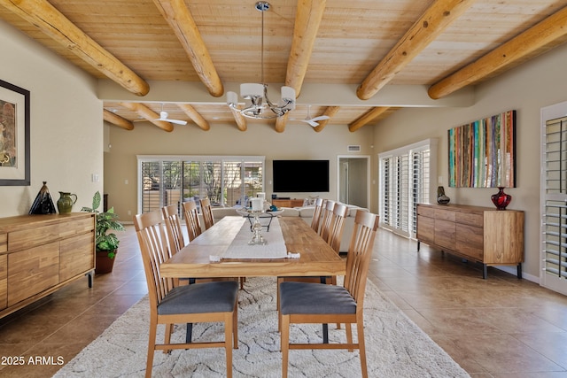 dining area with dark tile patterned floors, wooden ceiling, and beamed ceiling