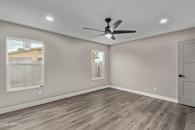 empty room with recessed lighting, ceiling fan, baseboards, and wood finished floors