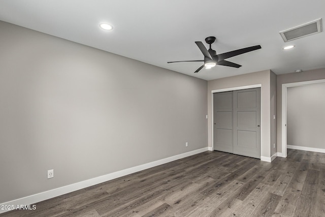 unfurnished bedroom featuring visible vents, wood finished floors, recessed lighting, a closet, and baseboards