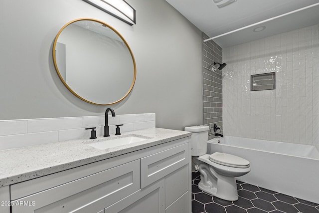 bathroom featuring tile patterned floors, shower / washtub combination, toilet, and vanity