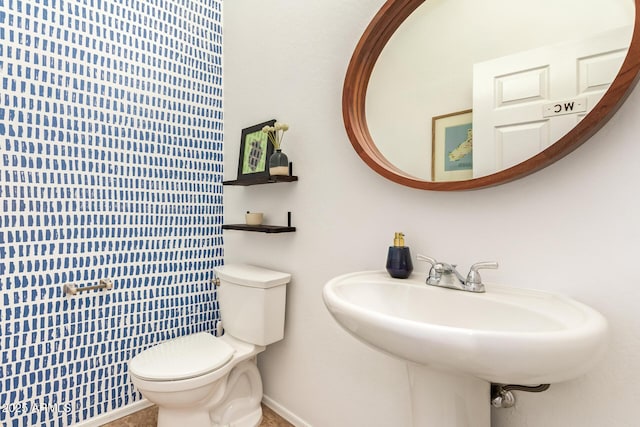 15862 W Fillmore St, Goodyear, AZ 85338 - bathroom with toilet, a sink, and baseboards