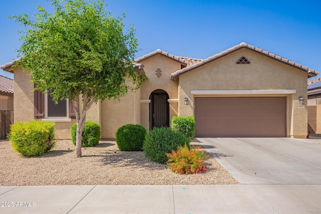 15862 W Fillmore St, Goodyear, AZ 85338 - mediterranean / spanish-style home with stucco siding, an attached garage, concrete driveway, and a tiled roof