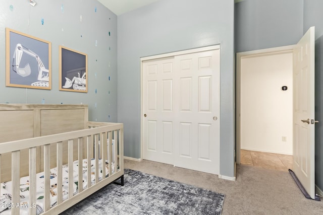 15862 W Fillmore St, Goodyear, AZ 85338 - bedroom with carpet floors, a nursery area, a closet, a towering ceiling, and baseboards