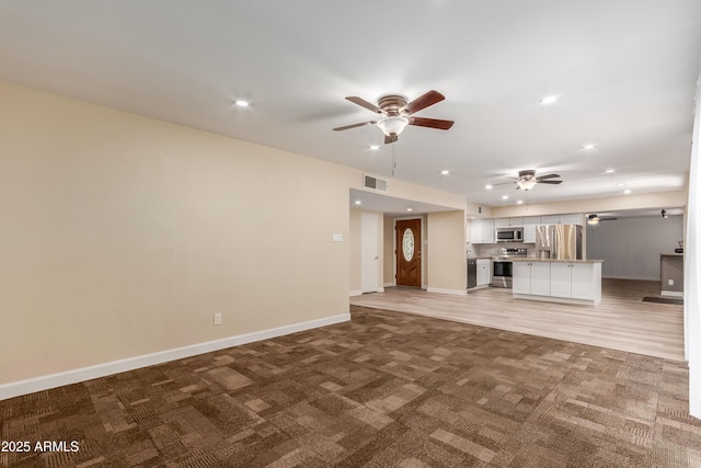 6009 W Medlock Dr, Glendale, AZ 85301 - unfurnished living room with a ceiling fan, light carpet, and recessed lighting
