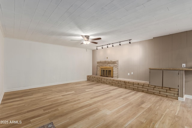 6009 W Medlock Dr, Glendale, AZ 85301 - unfurnished living room featuring a ceiling fan, track lighting, light wood finished floors, and a brick fireplace