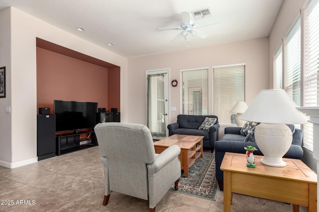 living area featuring ceiling fan, visible vents, and baseboards