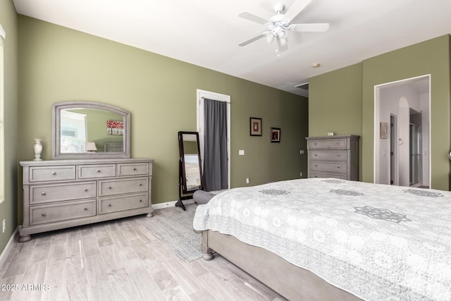 bedroom with light wood-style floors, ceiling fan, and baseboards