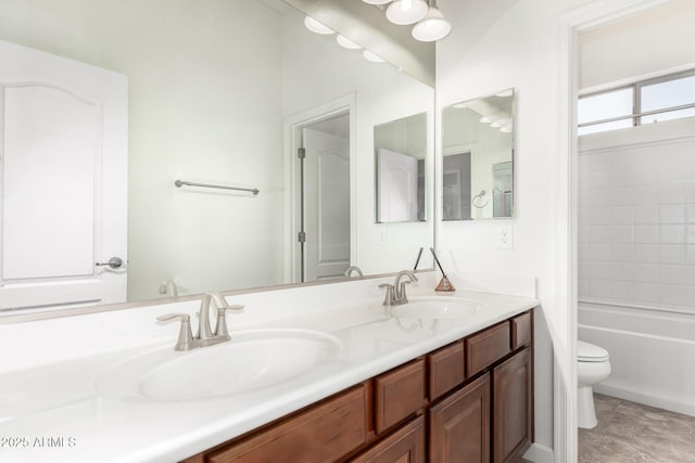 full bathroom featuring a sink, toilet, and double vanity