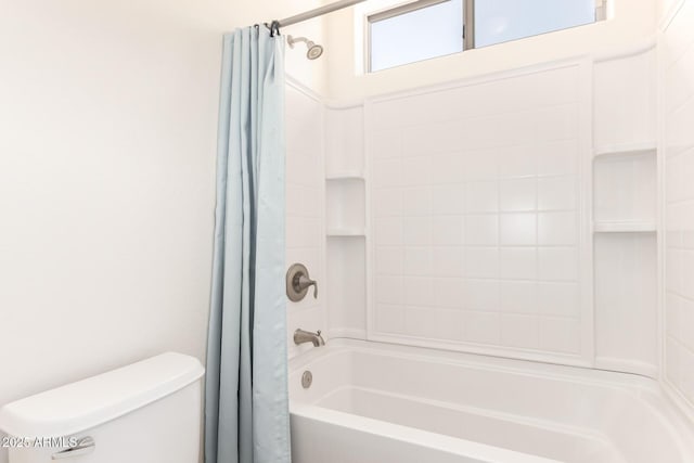 bathroom with toilet and shower / tub combo with curtain