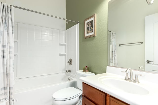 bathroom featuring shower / bath combo, a textured wall, vanity, and toilet