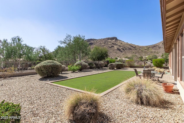 view of yard featuring fence and a mountain view