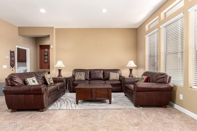 living area with baseboards, washer / dryer, and recessed lighting