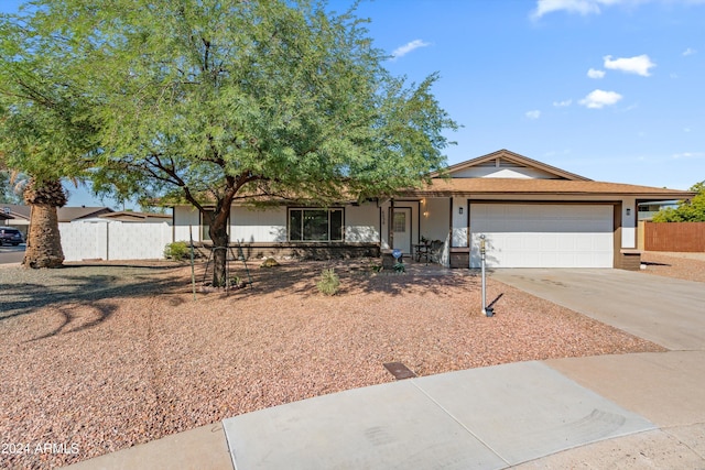 ranch-style home featuring a garage